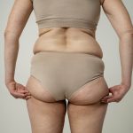 back view woman touching her body scaled 1.jpg