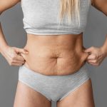 close up woman holding belly fat.jpg
