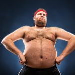 fat man imitating muscular build low angle view.jpg