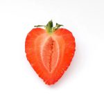 one fresh strawberries shape heart cut half white background.jpg