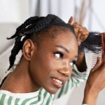 side view smiley woman combing hair.jpg
