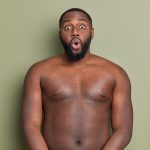 surprised adult man with beard stands shirtless stares front keeps mouth widely opened reacts something unexpected shocked isolated studio wall khaki color.jpg