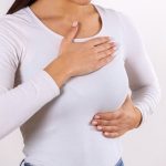 woman hand checking lumps her breast signs breast cancer gray background healthcare concept closeup woman s hand breast showing cancer symptom.jpg
