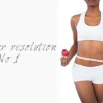 woman holding apple measuring her waist.jpg