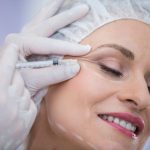 woman with marked face receiving botox injection.jpg